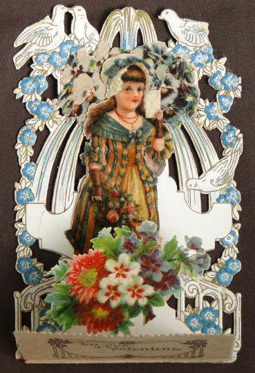アンティーク雑貨＞アンティーク・カード＞ヴィクトリアン・ポップアップカード＞To my Valentine　鳩と花に囲まれた少女が左手に封筒、右手に薔薇の花束を持っています。